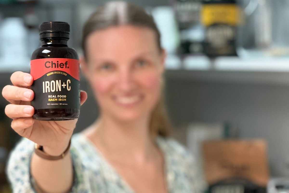 Woman holding Chief iron+C capsules